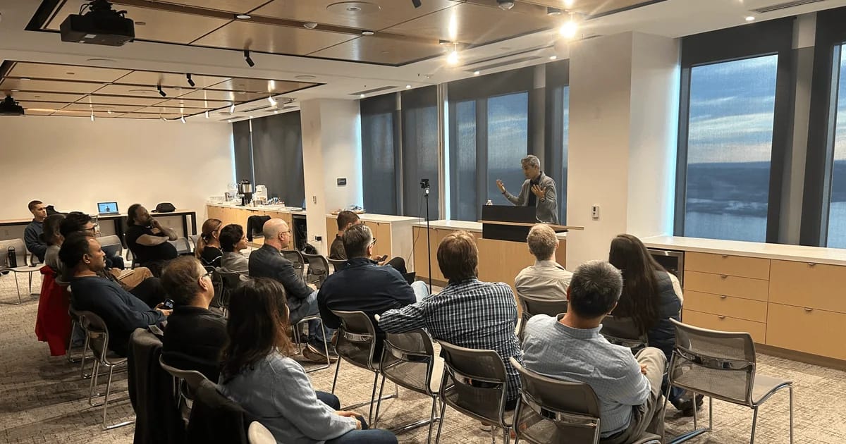 A speaker event with members seated and listening