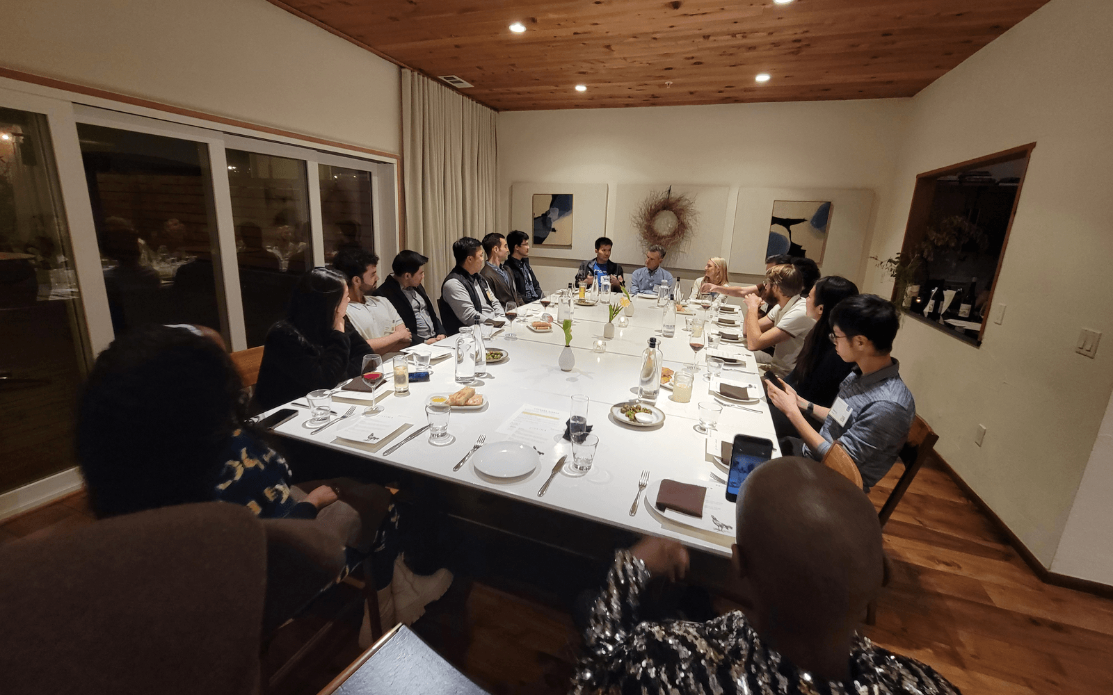 members around a dinner table in conversation