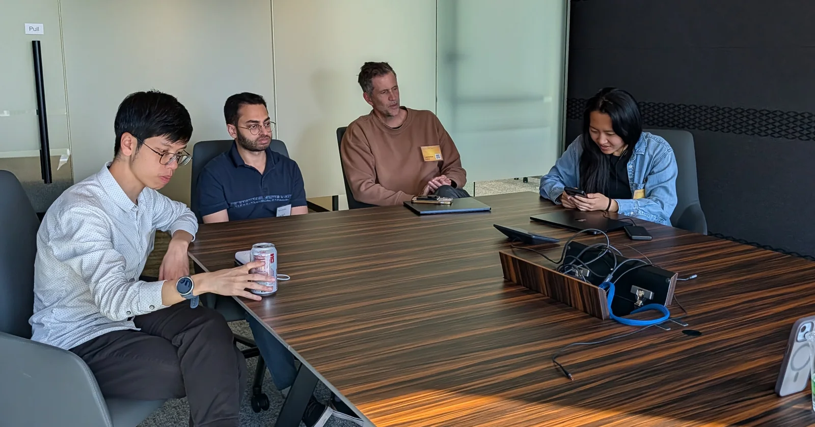 Four participants seated together around a conference table
